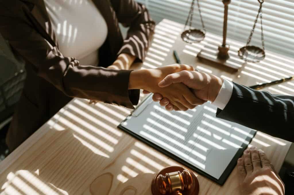 Legal handshake between attorneys at Morrissey Law Firm, emphasizing trust and client representation.