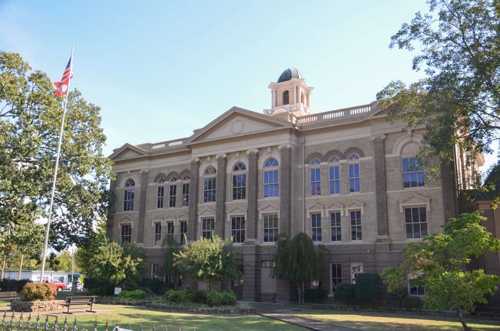 Historic courthouse building with classic architecture and surrounding greenery.