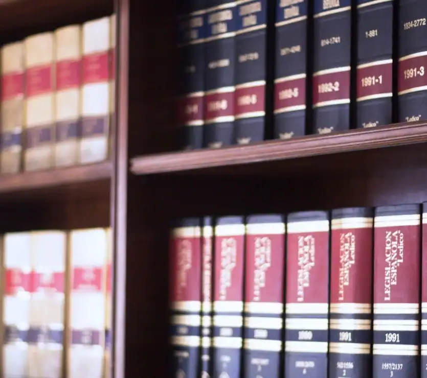 Law books on veteran legal cases in a law firm library.